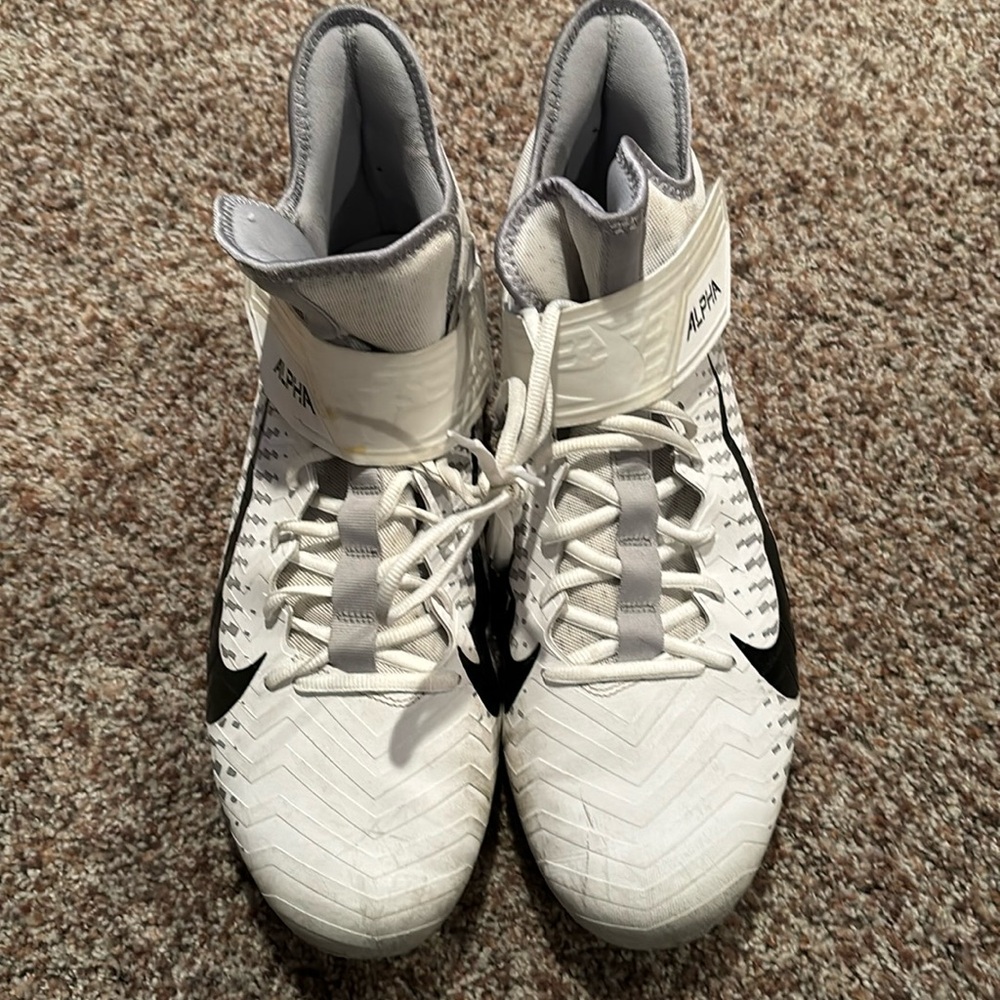 This is a pair of Nike Alpha cleats in size 15